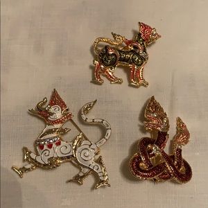 Three Asian Inspired brooches.